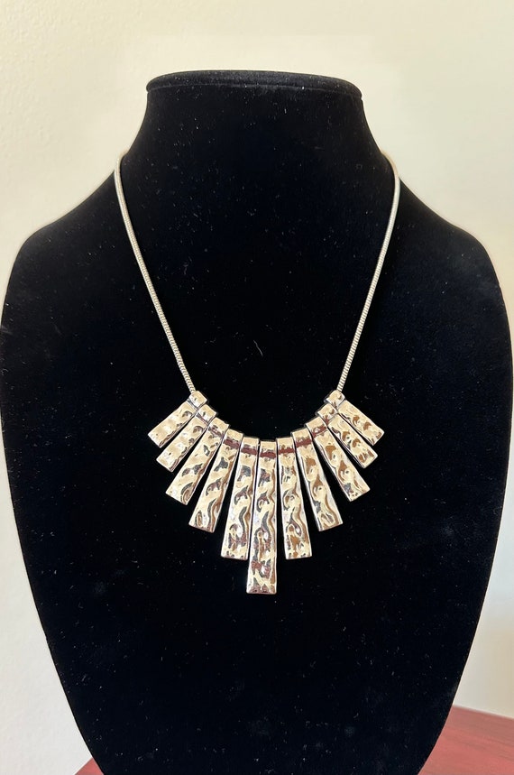 Silver tone hammered metal bib necklace