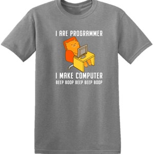 May include: A gray t-shirt with a humorous graphic of a cat sitting at a computer. The text on the shirt reads "I are programmer I make computer beep boop beep beep boop".