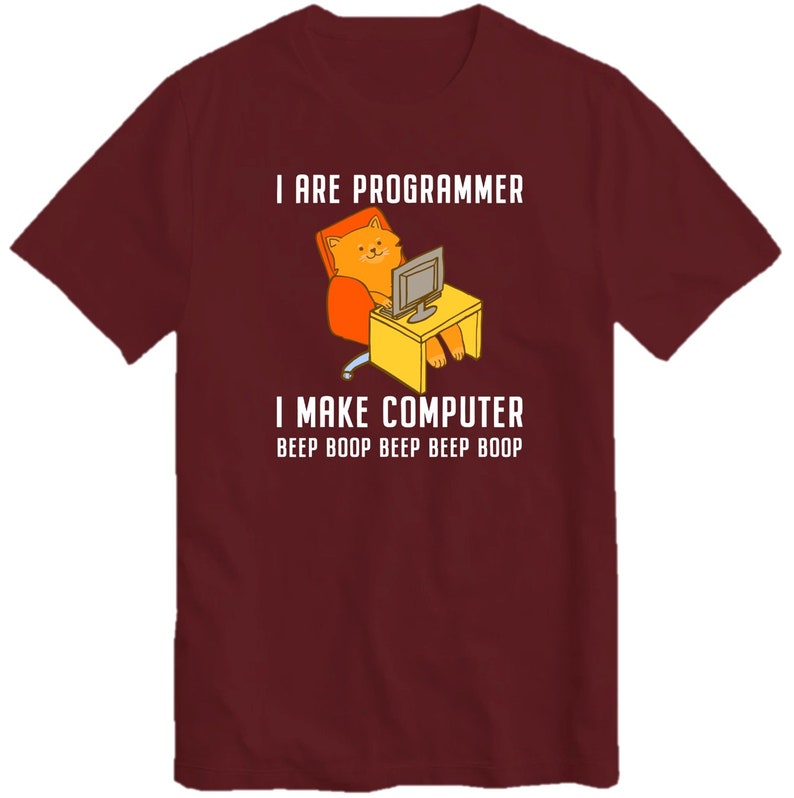 May include: A maroon t-shirt with a white graphic of a cat sitting in a chair and using a computer. The text on the shirt reads "I are programmer I make computer beep boop beep beep boop"