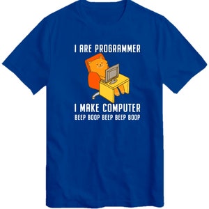 May include: A royal blue t-shirt with a cartoon cat sitting at a computer. The text on the shirt reads "I are programmer I make computer beep boop beep beep boop".