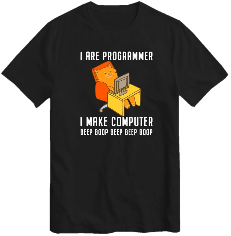 May include: Black t-shirt with a cartoon cat sitting in a chair and using a computer. The text on the shirt reads "I are programmer I make computer beep boop beep beep beep boop"