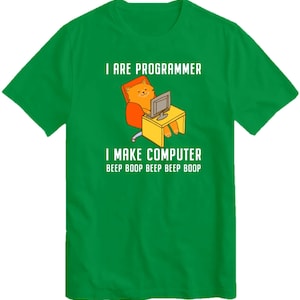 May include: Green t-shirt with a cartoon cat sitting in a chair and using a computer. The text on the shirt reads "I are programmer I make computer beep boop beep beep boop".