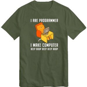 May include: A green t-shirt with a cartoon cat sitting at a computer. The text on the shirt reads "I are programmer I make computer beep boop beep beep boop".