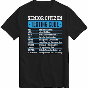 May include: Black t-shirt with white text that reads "Senior Citizen Texting Code" and a list of abbreviations and their meanings. The abbreviations are in blue text and the meanings are in white text.