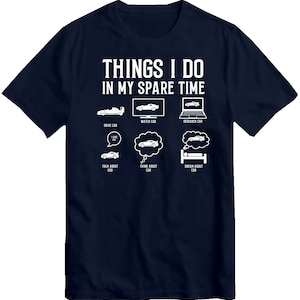 May include: A navy blue t-shirt with white text that reads "THINGS I DO IN MY SPARE TIME". The text is surrounded by illustrations of cars, including driving, watching, researching, talking about, thinking about, and dreaming about cars.