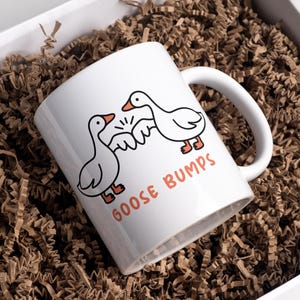 Goose Bumps mug.  2 geese first bumping