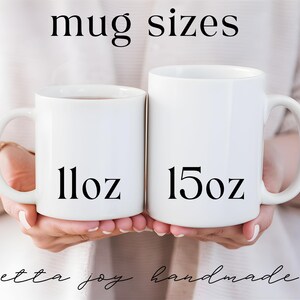 two white coffee mugs with numbers on them