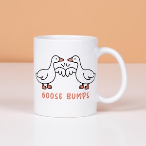 Goose Bumps mug.  2 geese first bumping