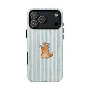 May include: A phone case with a light blue and white striped design. It features a watercolour illustration of an orange cat holding two fish. The phone case has a black camera module and black side buttons.