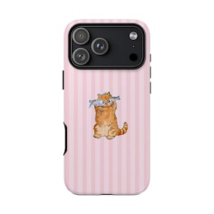 May include: Pink striped phone case featuring a ginger cat illustration holding two fish. The case has a triple-lens camera cutout and black side buttons. The case is designed for a smartphone.