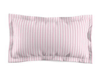 May include: A rectangular pillowcase with a pink and white striped pattern. The stripes run vertically across the pillowcase. The pillowcase has a soft, slightly wrinkled appearance.