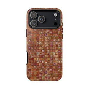 May include: A smartphone case with a mosaic tile design. The case features a pattern of small, square tiles in shades of brown, orange, and red. The phone's camera lenses are visible at the top. The case has a black side button.