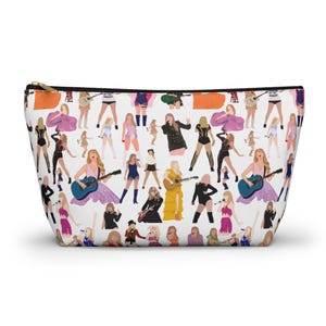 May include: White zippered cosmetic bag featuring a repeating pattern of stylized figures in performance poses. The figures are in various outfits, holding guitars and microphones. The bag has a gold-colored zipper.