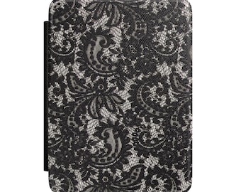 May include: E-reader cover with a black and white lace pattern. The cover displays a detailed floral lace design in black on a white backdrop. It has a black spine.