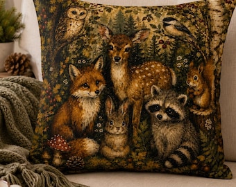 May include: A square throw cushion featuring a detailed forest scene with a fox, a deer, a rabbit, a raccoon, a squirrel, and an owl. The tapestry-style fabric displays rich green, brown, and orange tones, depicting woodland animals in nature.