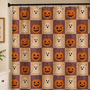 May include: A shower curtain featuring a repeating checkerboard pattern of orange jack-o'-lanterns and white ghosts on a light tan and purple background, hanging from a black rod in a bathroom with a white vanity and a framed sign reading WASH BRUSH FLOSS FLUSH.