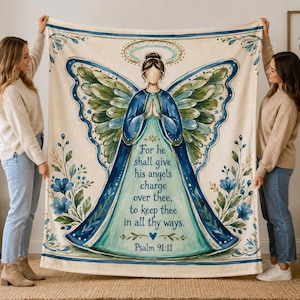 May include: A rectangular throw blanket featuring a central illustration of an angel with large blue and green wings and a halo. The text reads: For he shall give his angels charge over thee, to keep thee in all thy ways. Psalm 91:11.