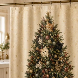 May include: A beige shower curtain featuring a printed Christmas tree decorated with ornaments and six kittens nestled within the branches. The background fabric has a subtle pattern of small gold stars and sparkles throughout the material.