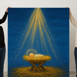 May include: A painting depicting a baby in a manger, illuminated by a golden light emanating from above. The artwork features a blue background with a halo around the baby's head and a bed of hay. The painting is held by two people.