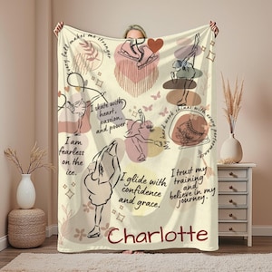 May include: Cream-colored blanket featuring ice skating illustrations and inspirational quotes. The design includes sketches of skaters, ice skates, hearts, and butterflies, with text such as "I am fearless on the ice" and the name "Charlotte".