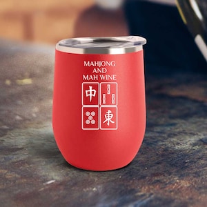 May include: Red stainless steel wine tumbler with a white design that says "Mahjong and Mah Wine" with Chinese characters and mahjong tiles.