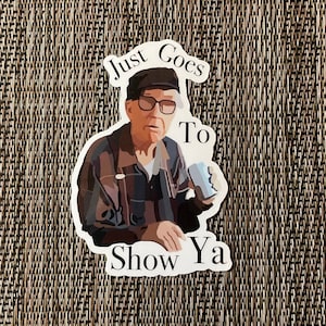 May include: A sticker featuring an illustration of an elderly man wearing glasses and a hat, holding a can. The text on the sticker reads "Just Goes To Show Ya."