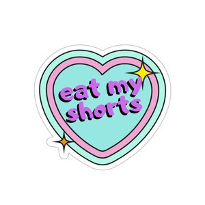 May include: A sticker in the shape of a heart with a pink and blue outline. The heart is light blue with the text "eat my shorts" in purple letters. There are two yellow stars on the sticker.