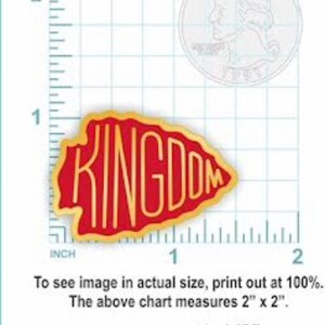 May include: A gold and red arrowhead-shaped pin with the word "KINGDOM" in gold lettering. The pin is 1 1/2 inches in size.