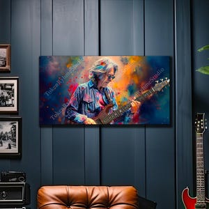 May include: A vibrant, abstract painting of a musician playing a bass guitar. The artwork features a colorful, splattered background with the musician in a blue and pink striped shirt. The image is a canvas print, with the text "TokenRhymeStudio" visible.