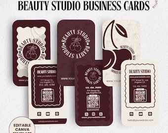 May include: Four different business card designs for a beauty studio. Each card features a cherry motif and the text "Beauty Studio". The cards also include contact information, a website address, and a QR code.