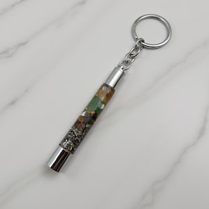 abundance wealth attraction crystal keychain on white marble