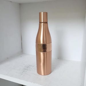 Premium copper water bottle with sleek cylindrical shape, wellness gift for men and women who value holistic living.