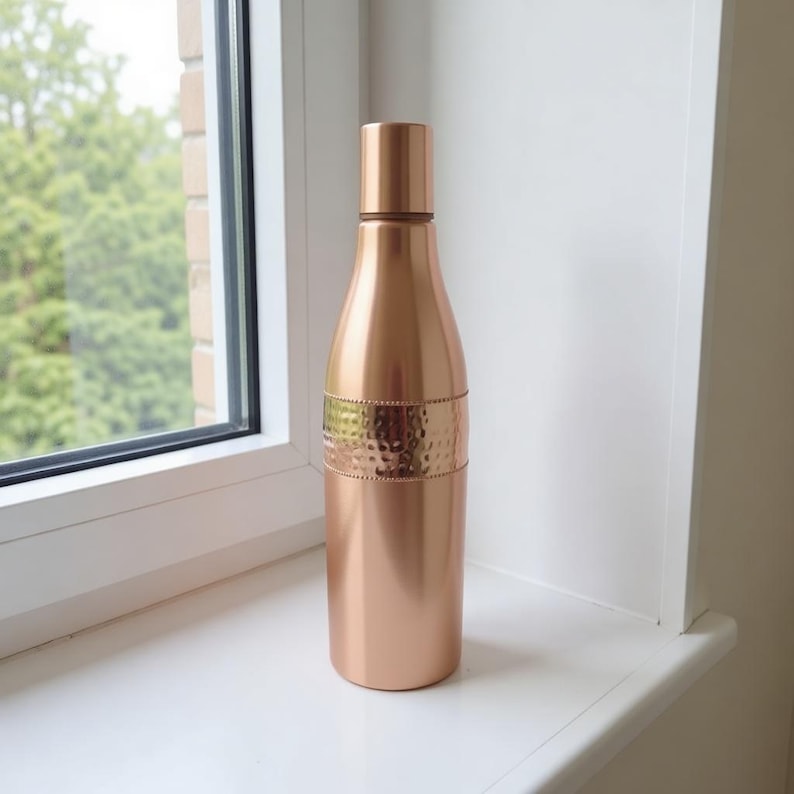 Handmade pure copper water bottle with polished rose gold finish, eco friendly reusable Ayurvedic drinking bottle perfect for yoga lifestyle and holistic wellness.