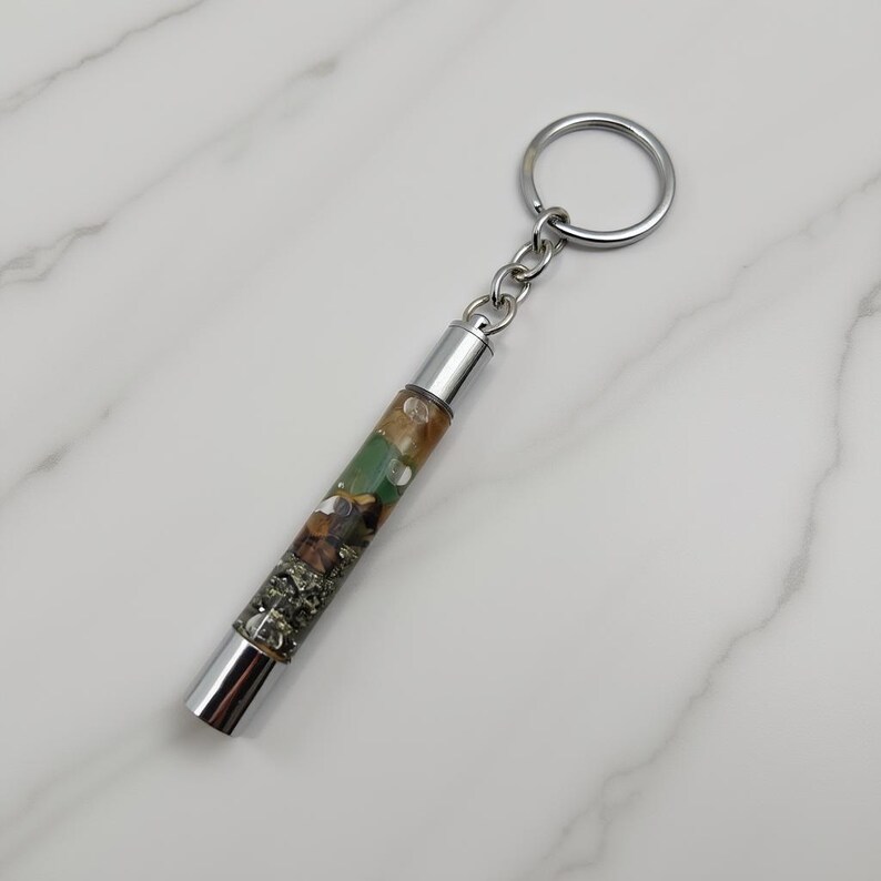 abundance wealth attraction crystal keychain on white marble