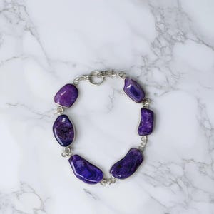 Genuine amethyst crystal bracelet showing purple natural stones
