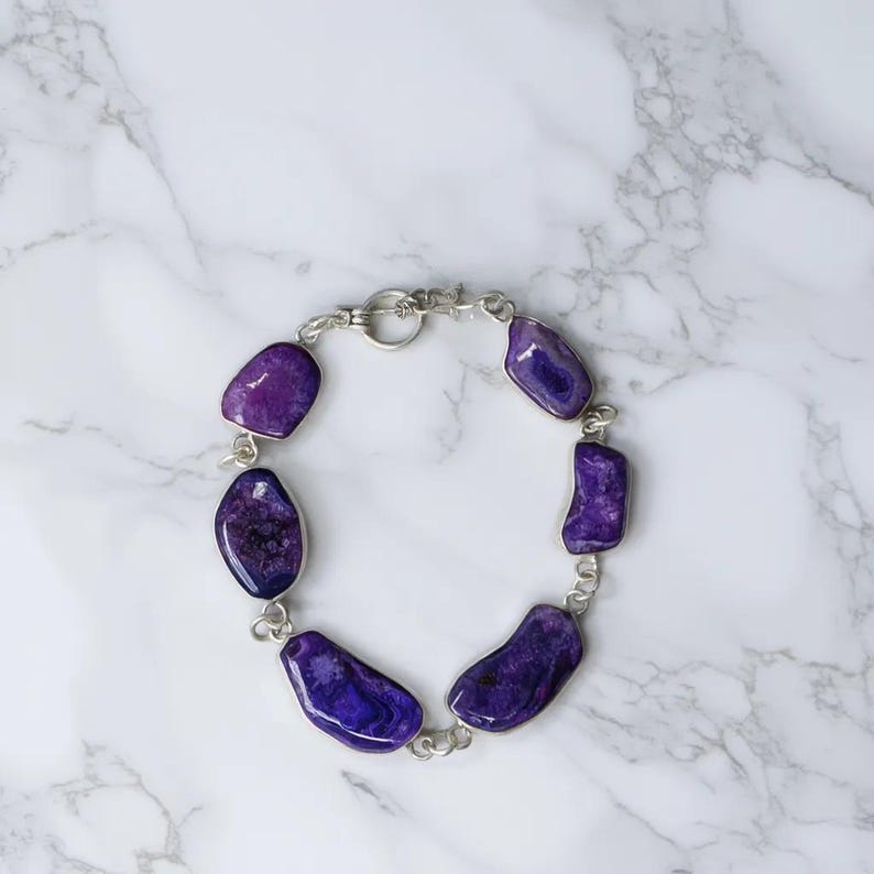 Genuine amethyst crystal bracelet showing purple natural stones