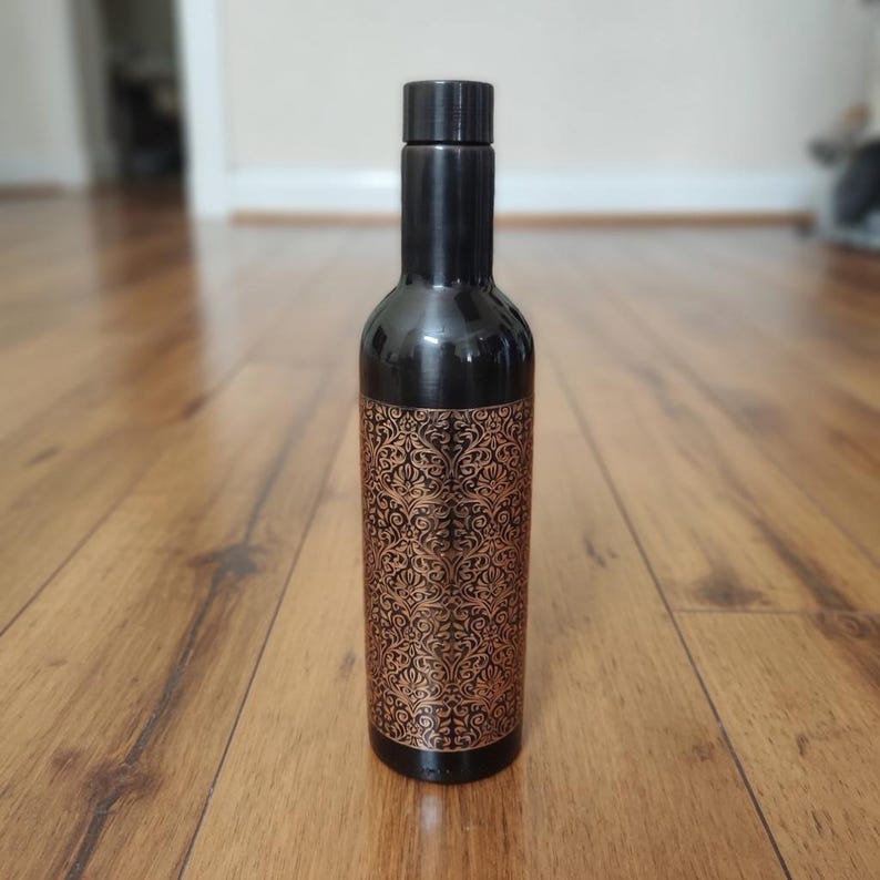 Stylish copper drinking bottle for modern office and yoga enthusiasts, reusable metal water container with wellness appeal.