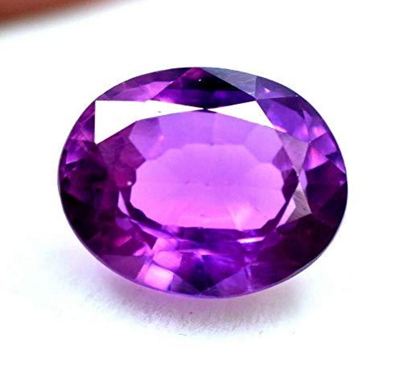 "Premium 8-9 carat oval cut purple sapphire gemstone, ideal for making pendants or earrings"