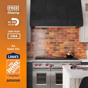May include: A modern kitchen with a stainless steel range and a black range hood. The backsplash is made of brick-style tiles in shades of orange and brown. White cabinets and a white countertop complete the design. The image also includes text that says "FREE Shipping", "30 Day Returns", and "SHIPS FROM USA".