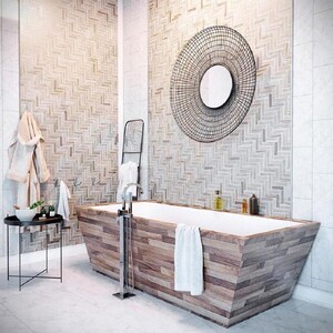 May include: A white bathtub with a wooden exterior sits in a bathroom with white tile walls and a herringbone pattern tile accent wall. A large round black metal mirror hangs on the accent wall.