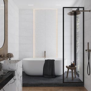 May include: A white bathtub with a black towel on the edge, in a modern bathroom with white tile walls and a black framed glass shower enclosure.