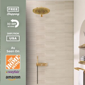 May include: A gold-colored shower head and matching fixtures are mounted on a light-colored, patterned wall. The image also shows a towel rack, shelves, and the text "As Seen On The Home Depot, Wayfair, Amazon."