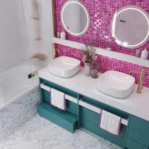 May include: A white bathroom vanity with two white porcelain sinks and gold faucets. The vanity has teal cabinets with white towel bars and a white countertop. The backsplash is pink mosaic tiles with two round mirrors with gold trim.