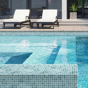 May include: A swimming pool with a light blue tiled surface and a shallow step. Two white lounge chairs are positioned near the pool.