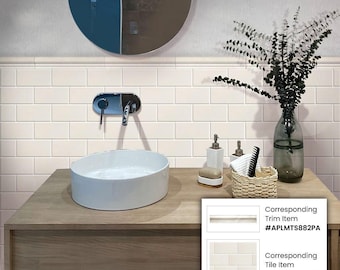 May include: White subway tile bathroom with a white porcelain sink and a wooden vanity. The vanity has a white trim piece above it. The corresponding trim item is #APLMT5882PA and the corresponding tile item is #APLFT58836PA.