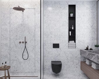 May include: A modern bathroom with white marble tile walls and flooring. Features include a walk-in shower with a bronze showerhead, a black toilet, and a wooden stool with toiletries. A built-in shelf holds towels and bath products.