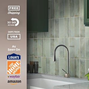 May include: Kitchen interior with green vertical tiles, a stainless steel faucet, and a white sink. The image also shows green cabinets and a small vase with white flowers. The text in the image says "As Seen On" Lowe's, The Home Depot, Wayfair, and Amazon.