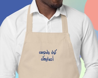 Delantal de algodón orgánico bordado "Come y chúpate los dedos" (كول ولحوس أصابيعك), kol w lahwis asabee3ak, refrán libanés, comida deliciosa