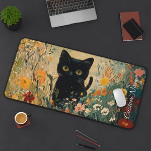 May include: A rectangular desk mat featuring a black cat with yellow eyes amidst a colorful floral design. The mat includes the text "Custom Name" in a script font. A computer mouse rests on the mat.