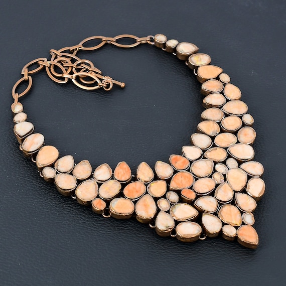 Electroforming is a genuinely niche craft — molten copper is electrically deposited directly onto a real gemstone, creating an organic metal skin you can't replicate with casting.